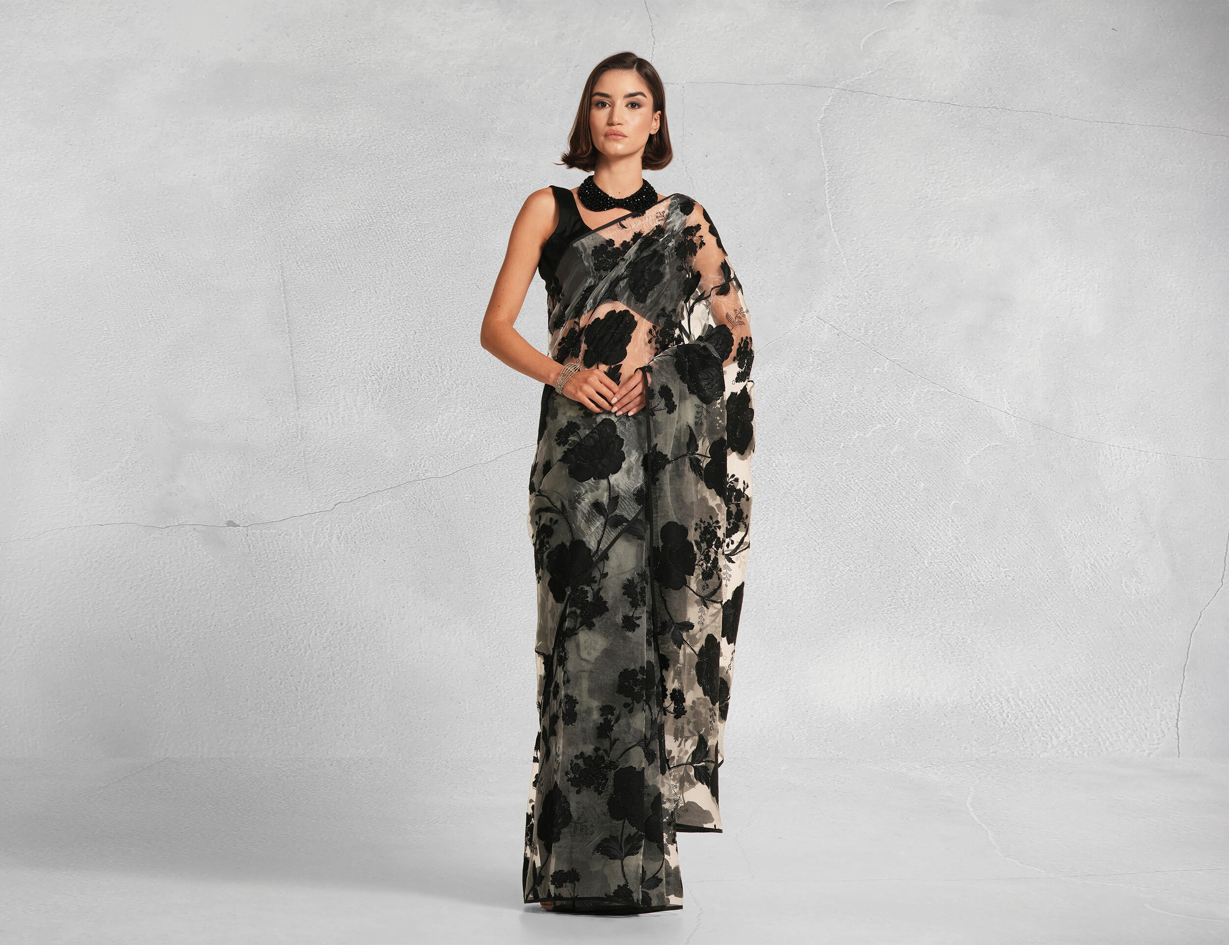 A woman flaunting her black sequin saree
